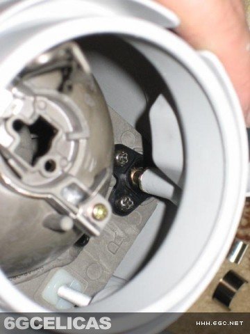Exposed projector housing showing adjustment screws and ball joint